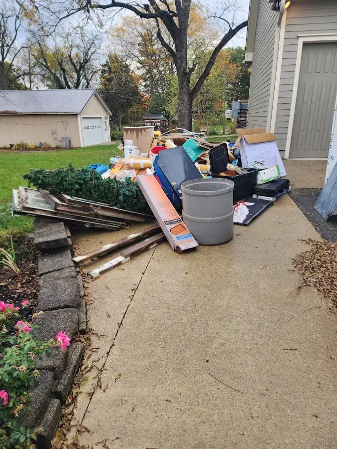 Dumpster being loaded with debris for Roofing Dumpster Rental in Vinita
